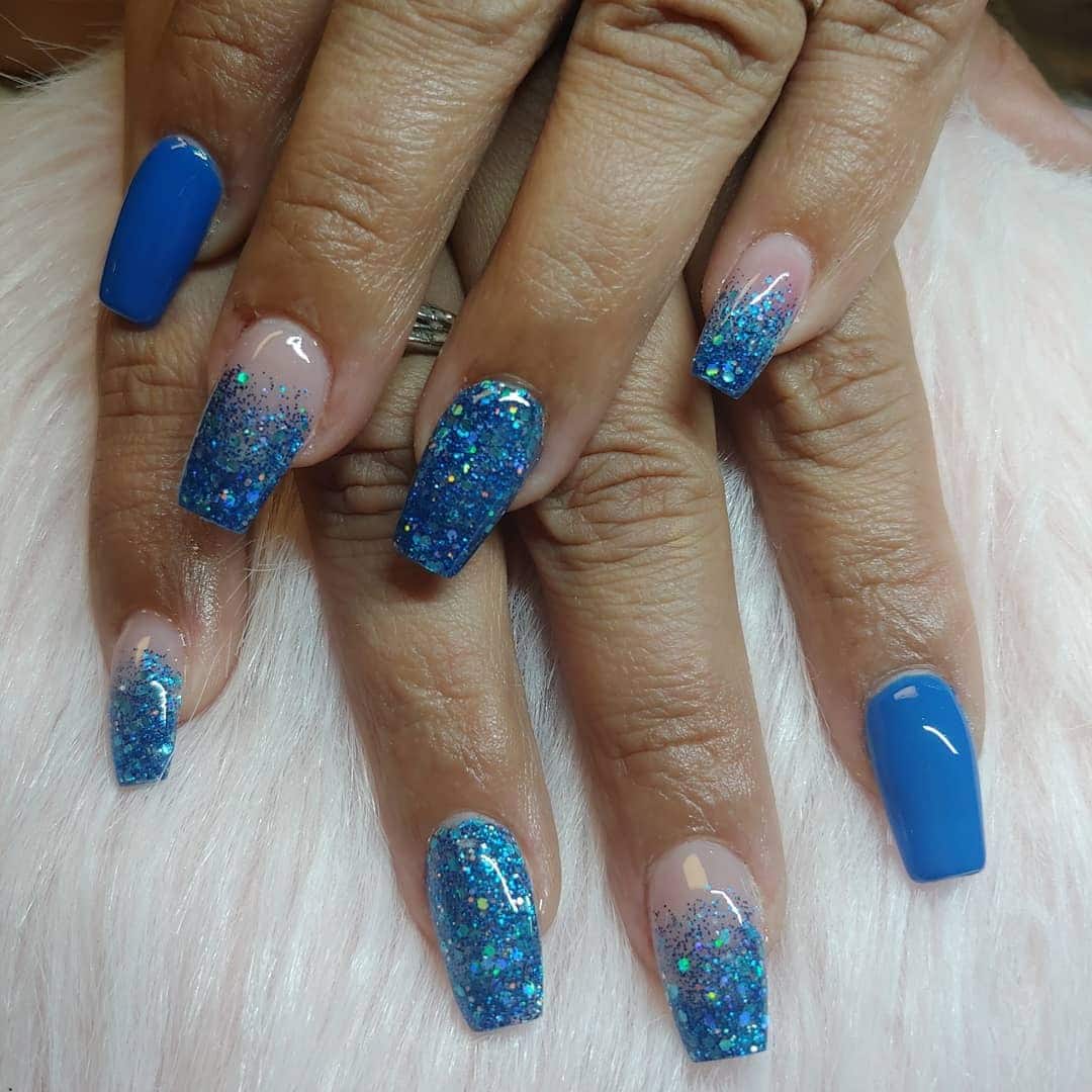 14. Glitter Gradient with Sapphire Accent - blue glitter nail ideas