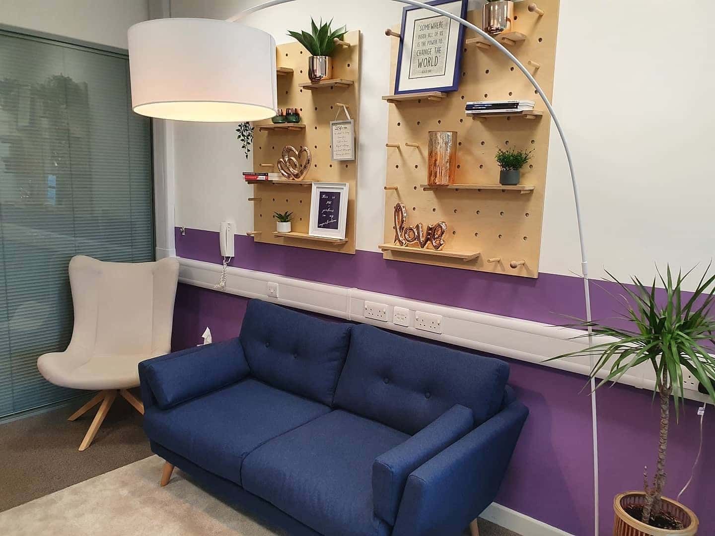 11. Modern Purple Accent Lounge - purple office ideas