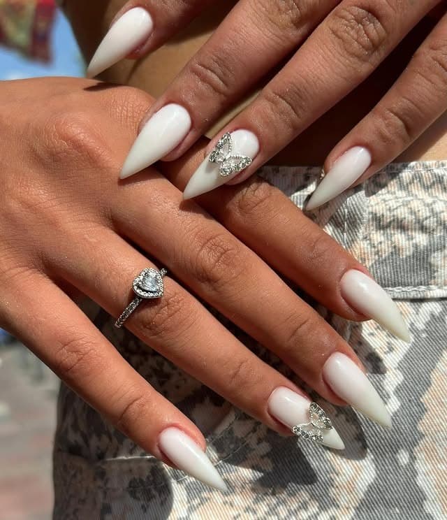 3. White Almond Elegance with Butterfly Charms - boho nail ideas
