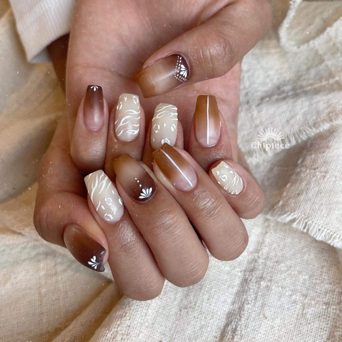 6. Earthy Brown Gradient with White Detailing - boho nail ideas