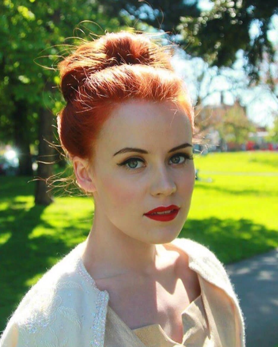 12. Classic High Bun with Vibrant Copper Red Hair - Easy Hairstyles