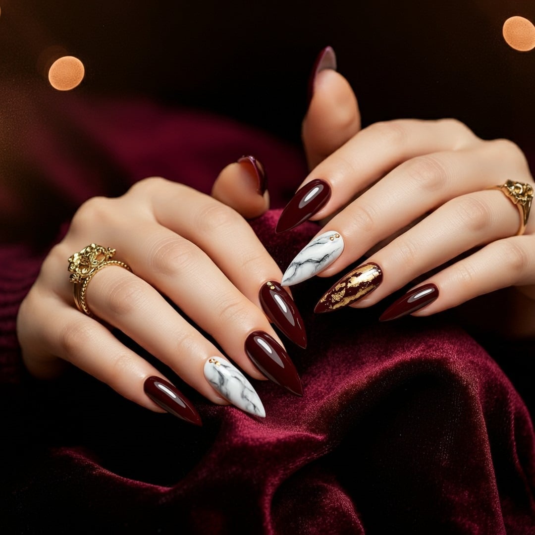 2. Elegant Burgundy with Marble and Metallic Detail - burgundy and gold nail ideas