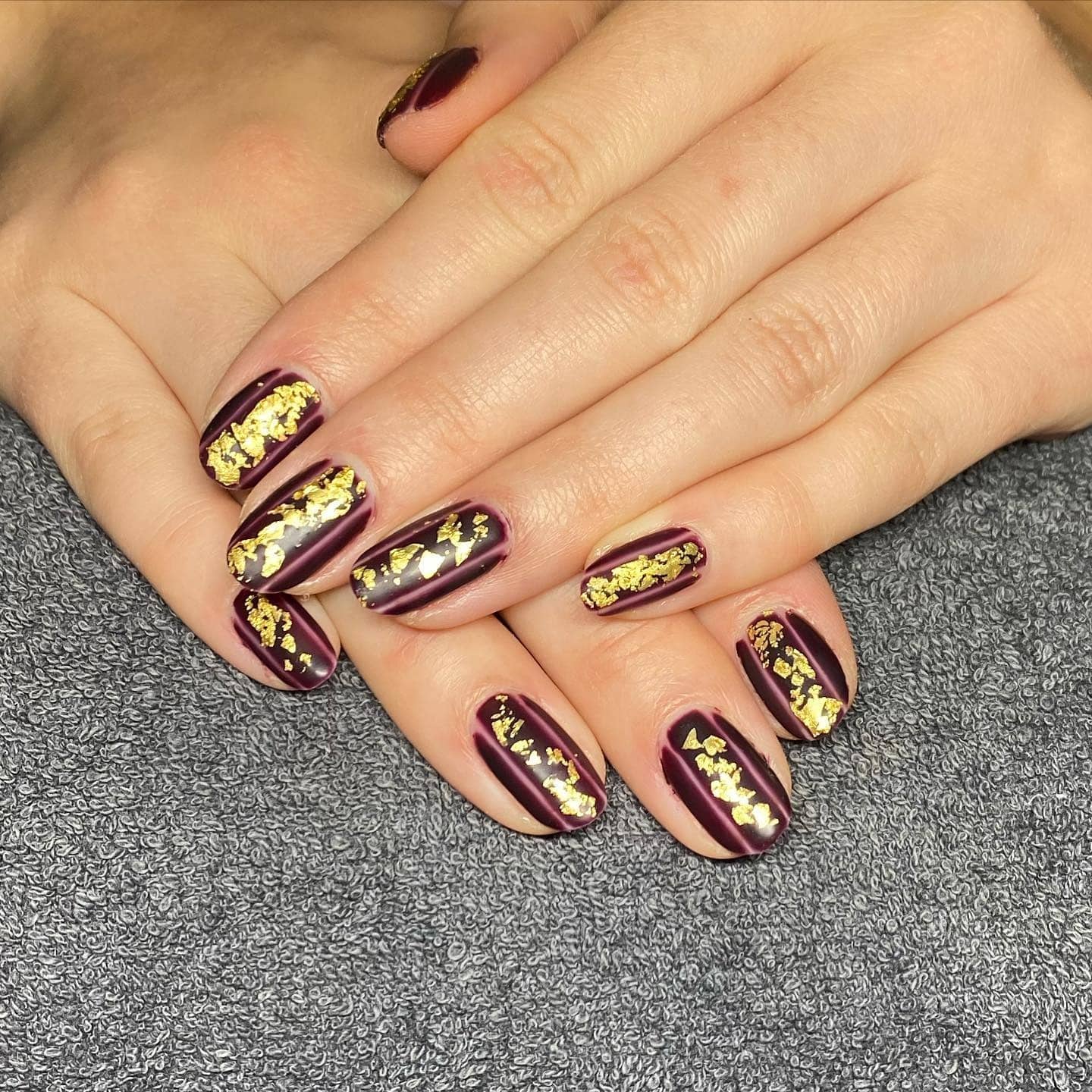 5. Burgundy Nails with Gold Foil Streaks - burgundy and gold nail ideas