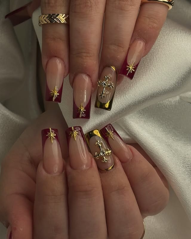 11. Burgundy French Tips with Golden Cross Detail - burgundy and gold nail ideas