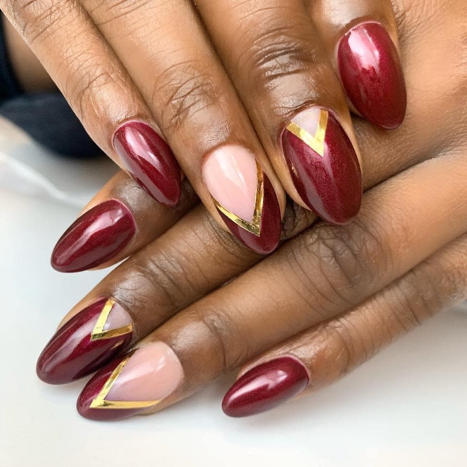 15. Burgundy Chevron with Golden Accent Lines - burgundy and gold nail ideas