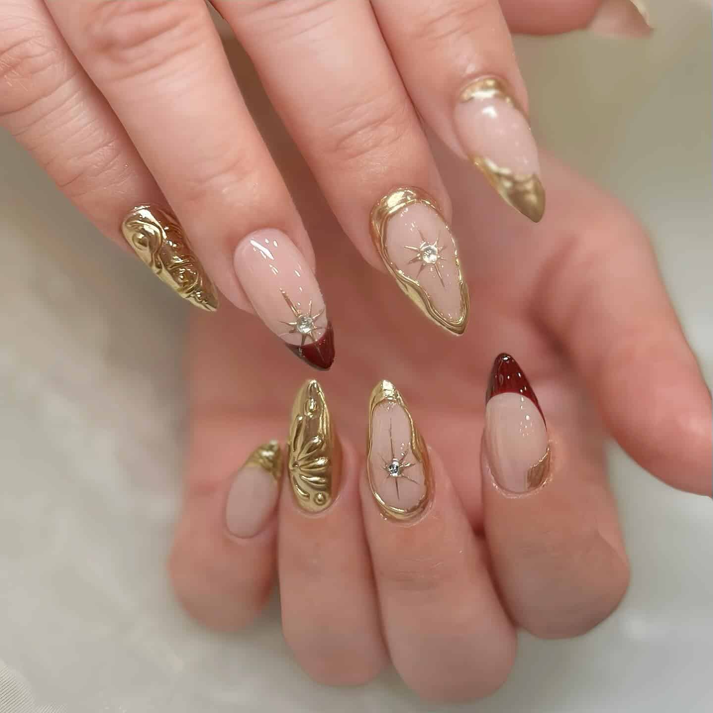18. Burgundy-Tipped Nails with Golden Stars - burgundy and gold nail ideas