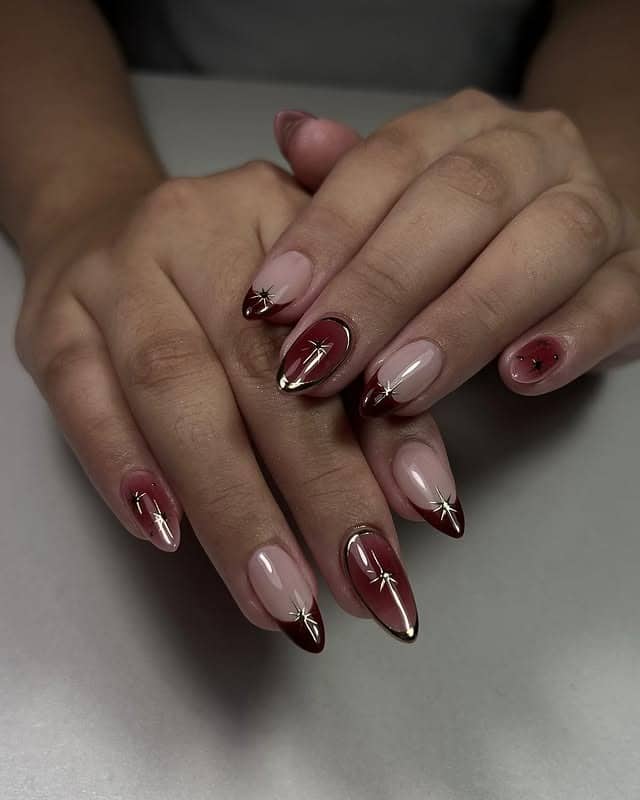 20. Burgundy Ombre with Golden Star Detailing - burgundy and gold nail ideas