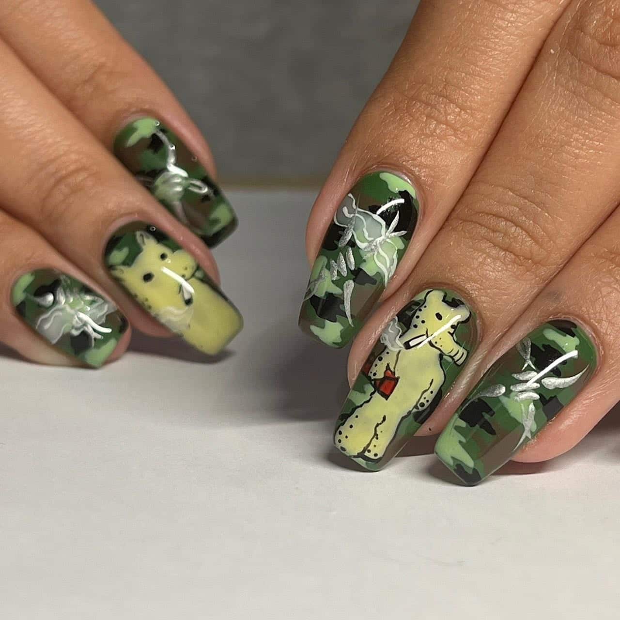 8. Artistic Camouflage Story - camouflage nail ideas