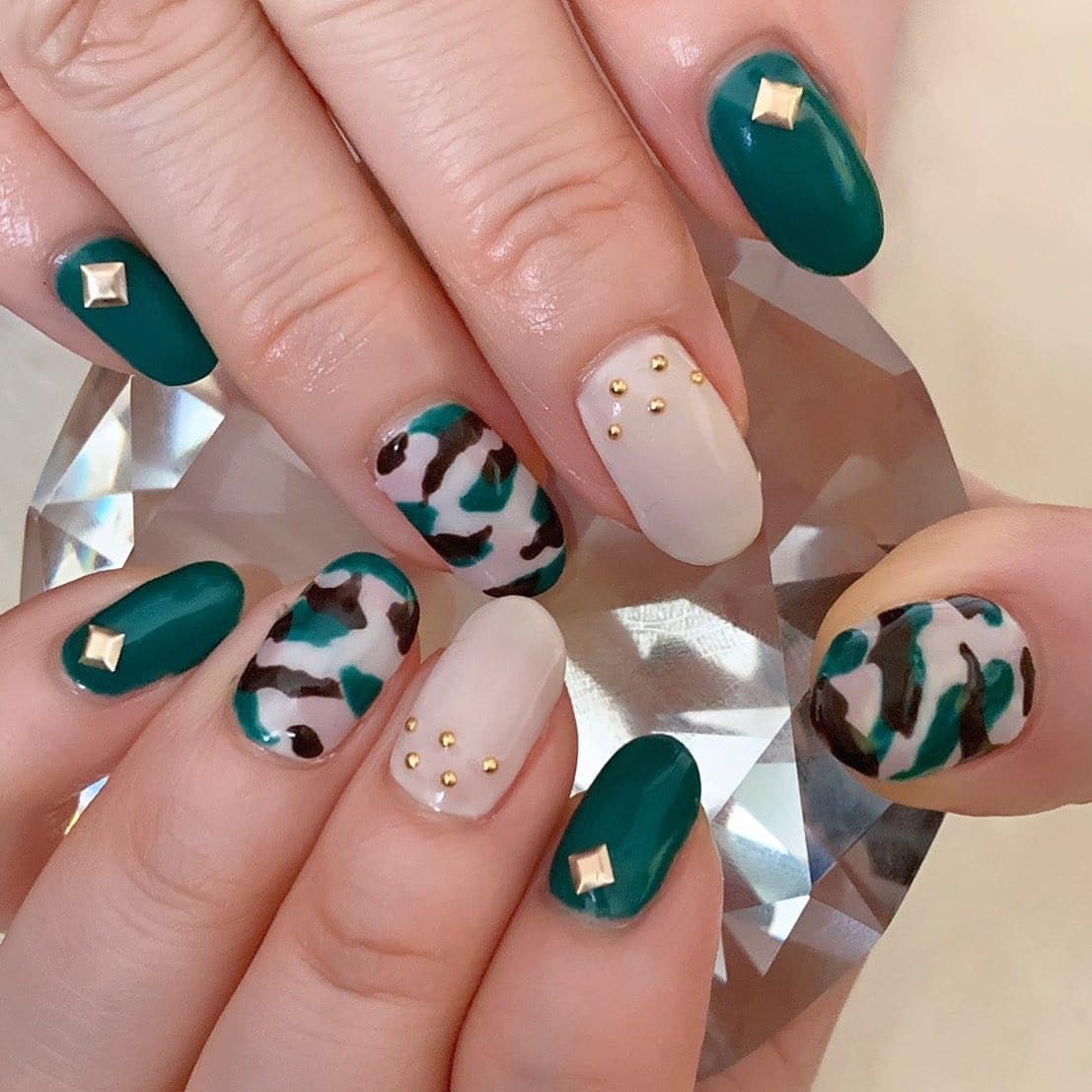 10. Emerald Camouflage with Gold Studs - camouflage nail ideas