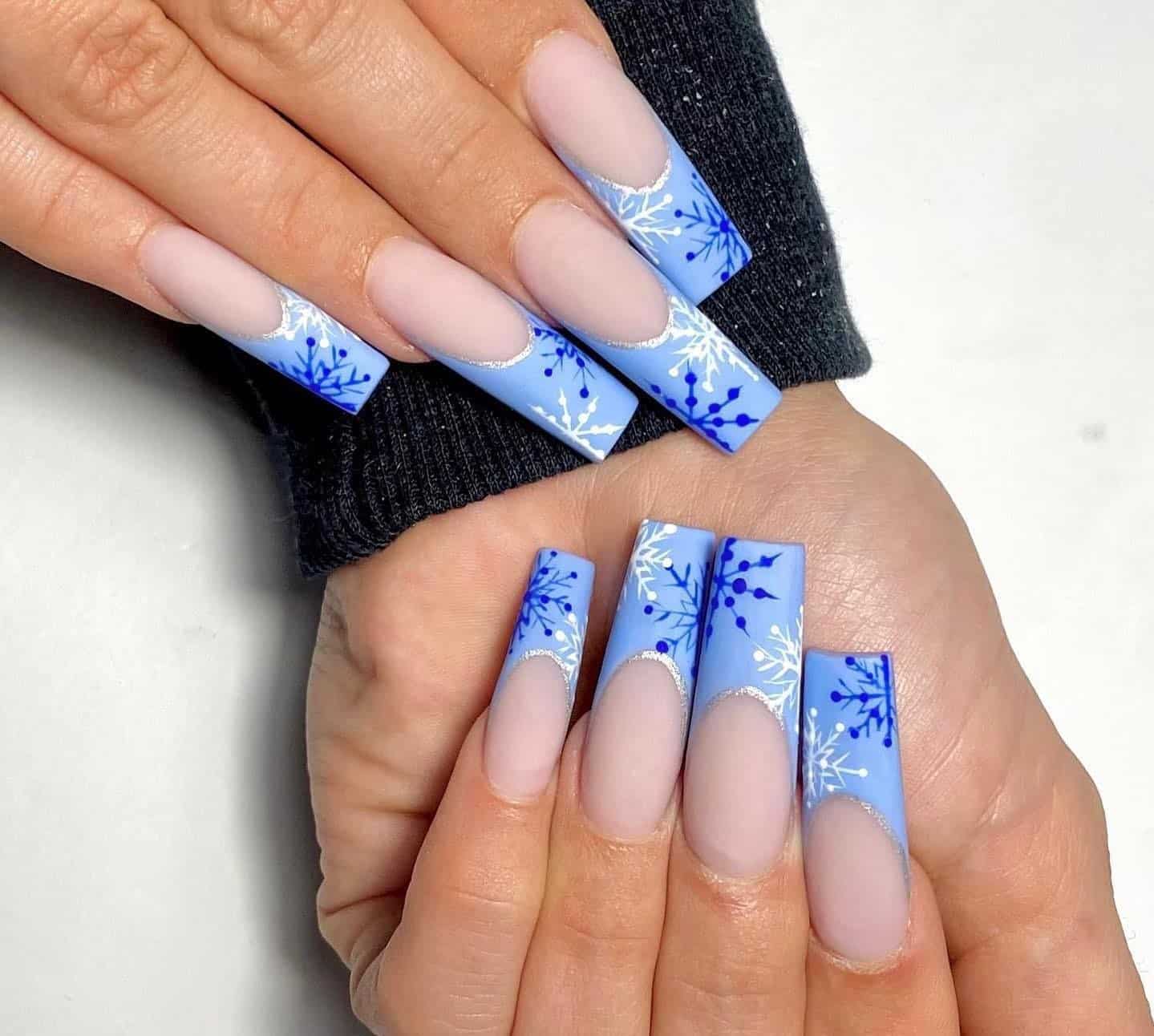 8. Icy Blue Snowflake French Tips - christmas french tip nail ideas