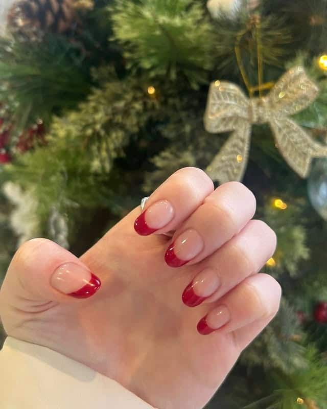 20. Glossy Cherry Red French Tips - christmas french tip nail ideas