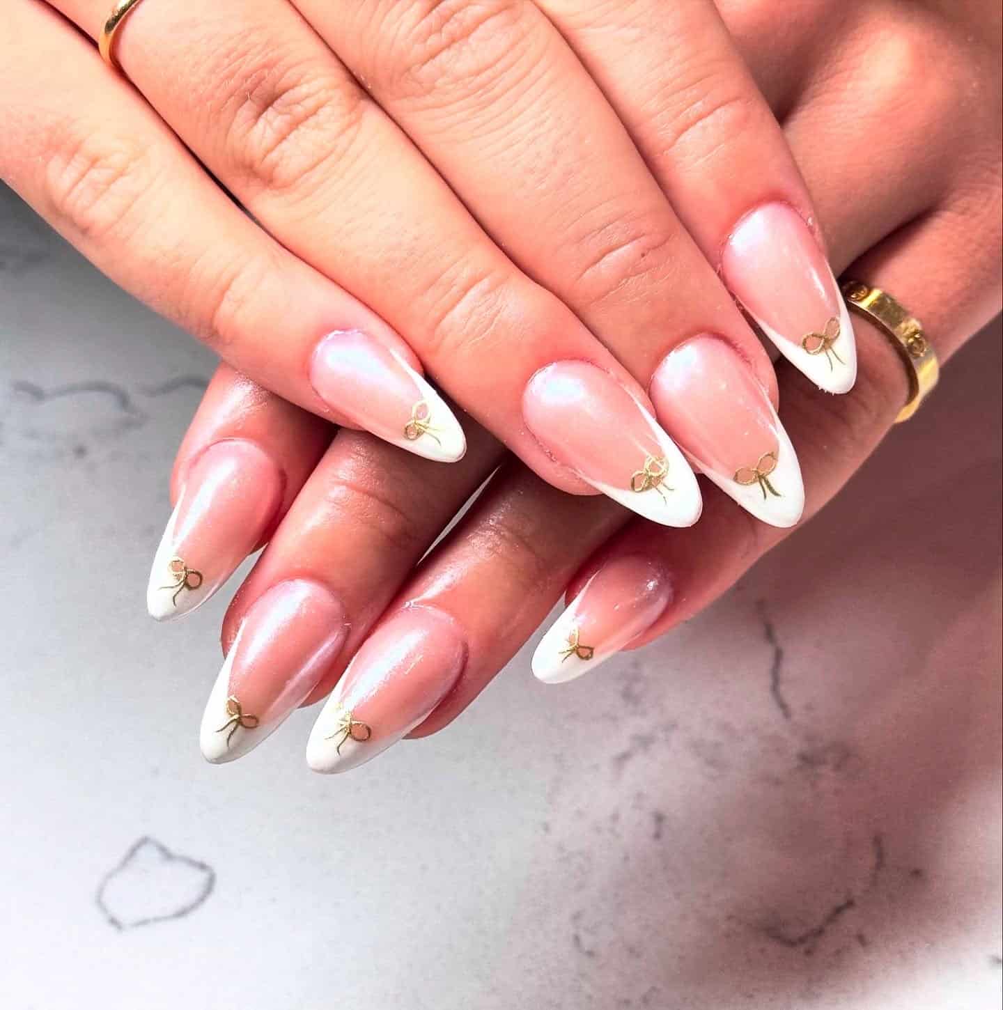 21. Golden Bow French Tips - christmas french tip nail ideas