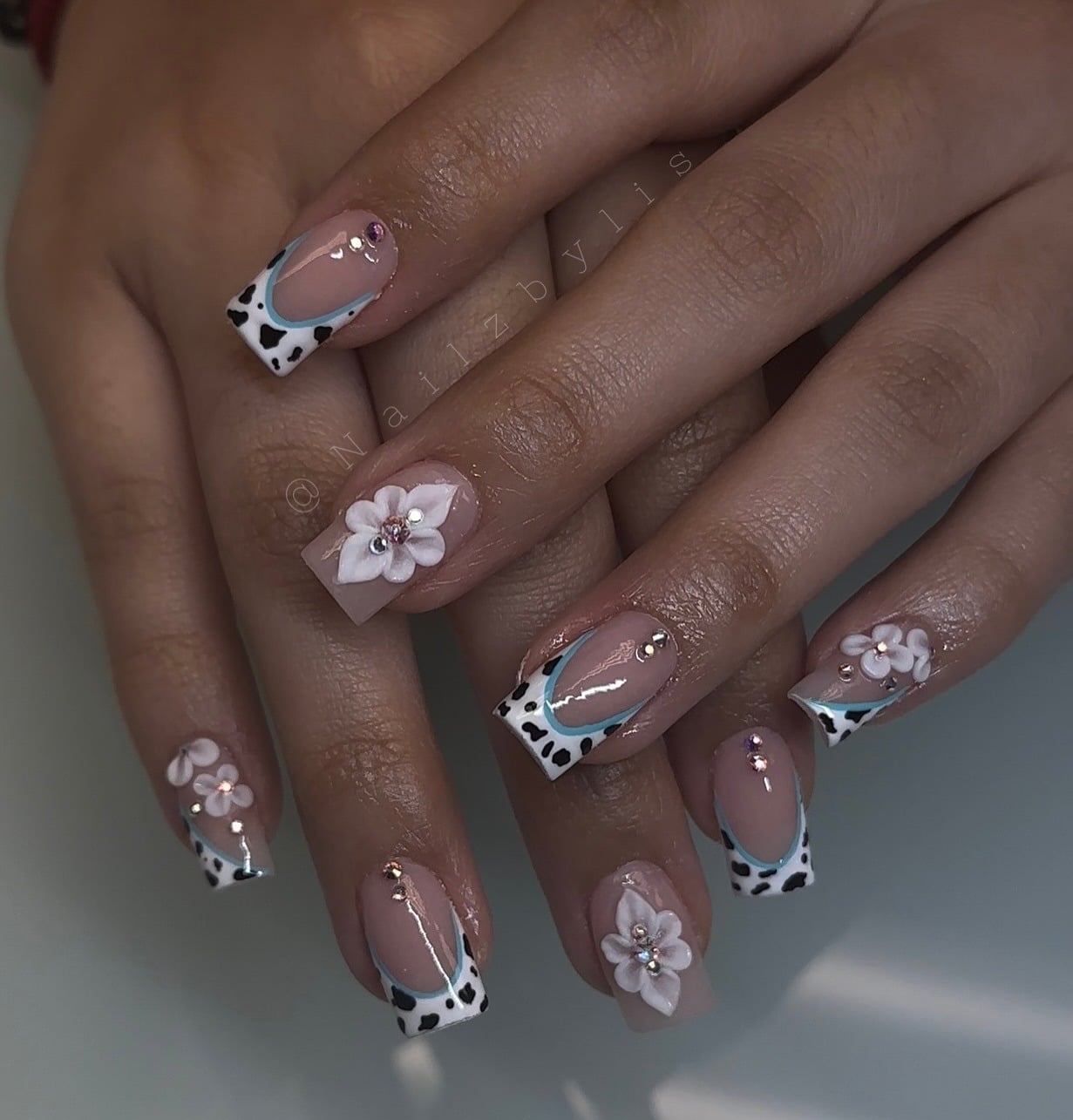 13. Cow Print French with 3D Blossoms - cowgirl nail ideas