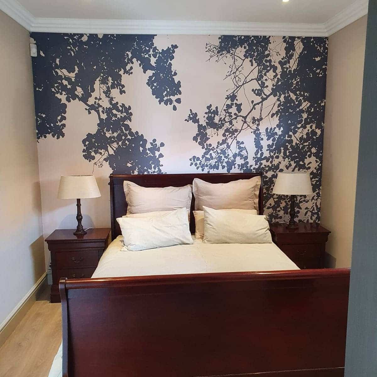 4. Nature-Inspired Silhouette Accent Wall - wallpaper ideas for bedroom