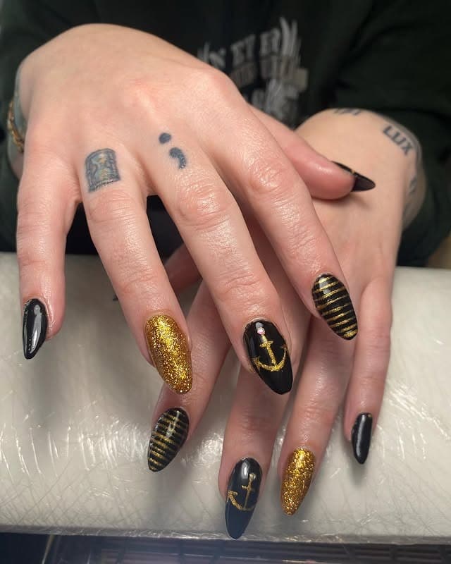 8. Black & Gold Anchors - cruise ship nail ideas