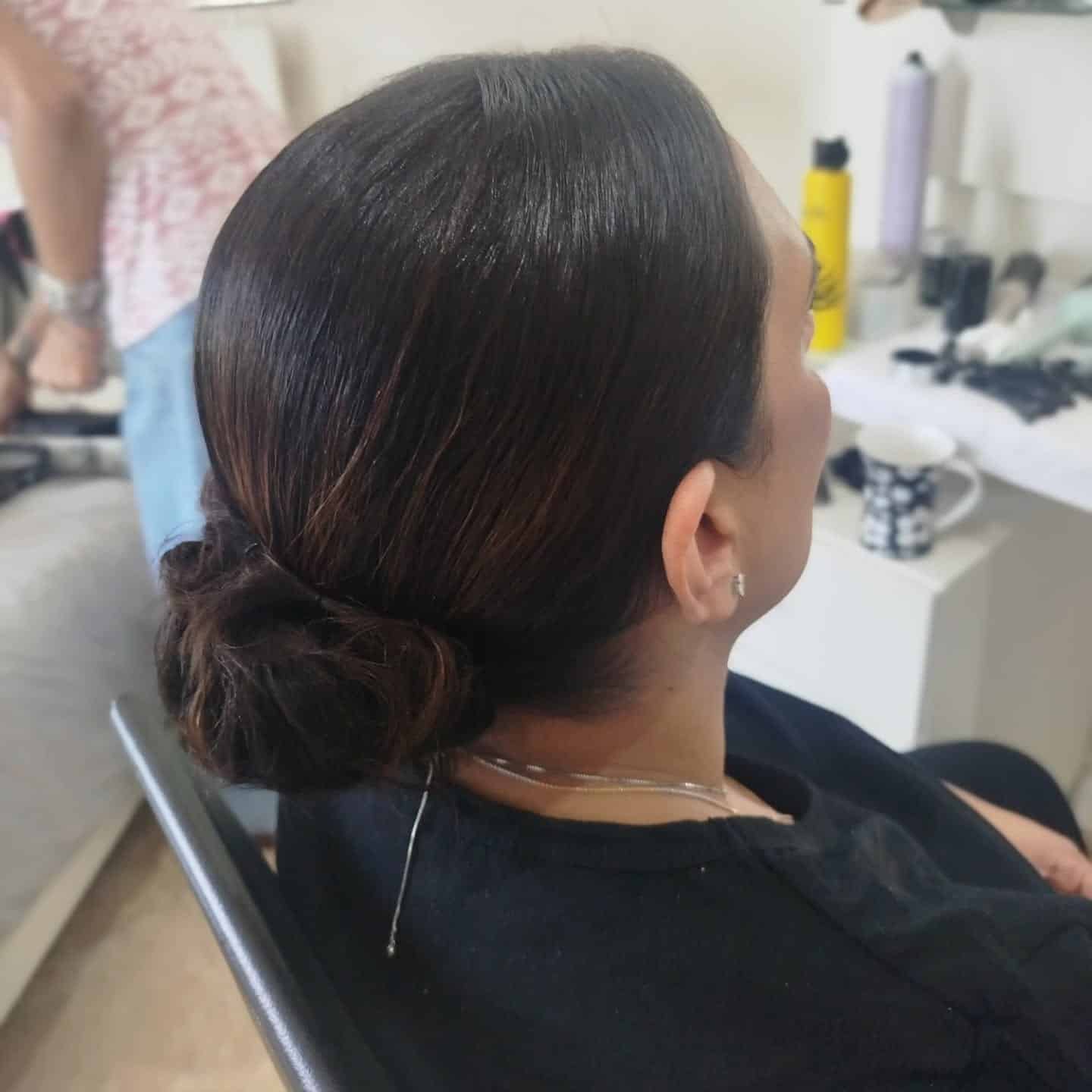 2. Glossy Low Knot with Espresso Depth - Sleek Hairstyles