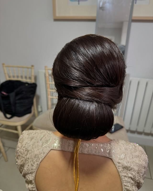 12. Sculpted Low Bun with Deep Espresso Shine - Sleek Hairstyles