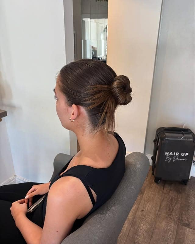 16. Compact Knot Bun with Subtle Caramel Tones - Sleek Hairstyles