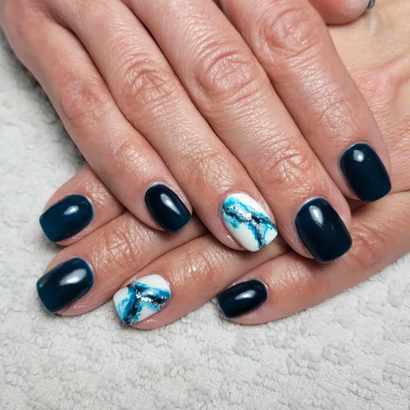 8. Teal Marble Accent Design - dark teal nail ideas
