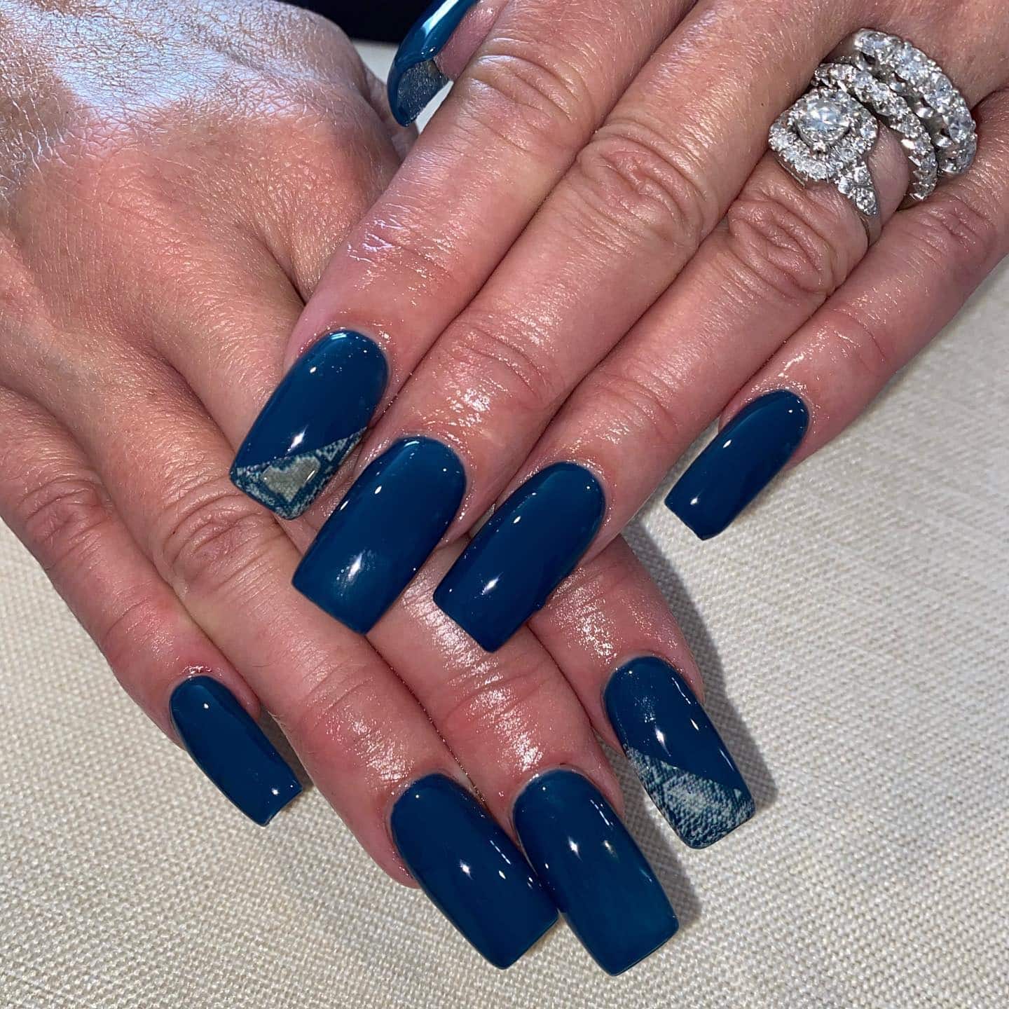 12. Glossy Teal with Subtle Accent - dark teal nail ideas