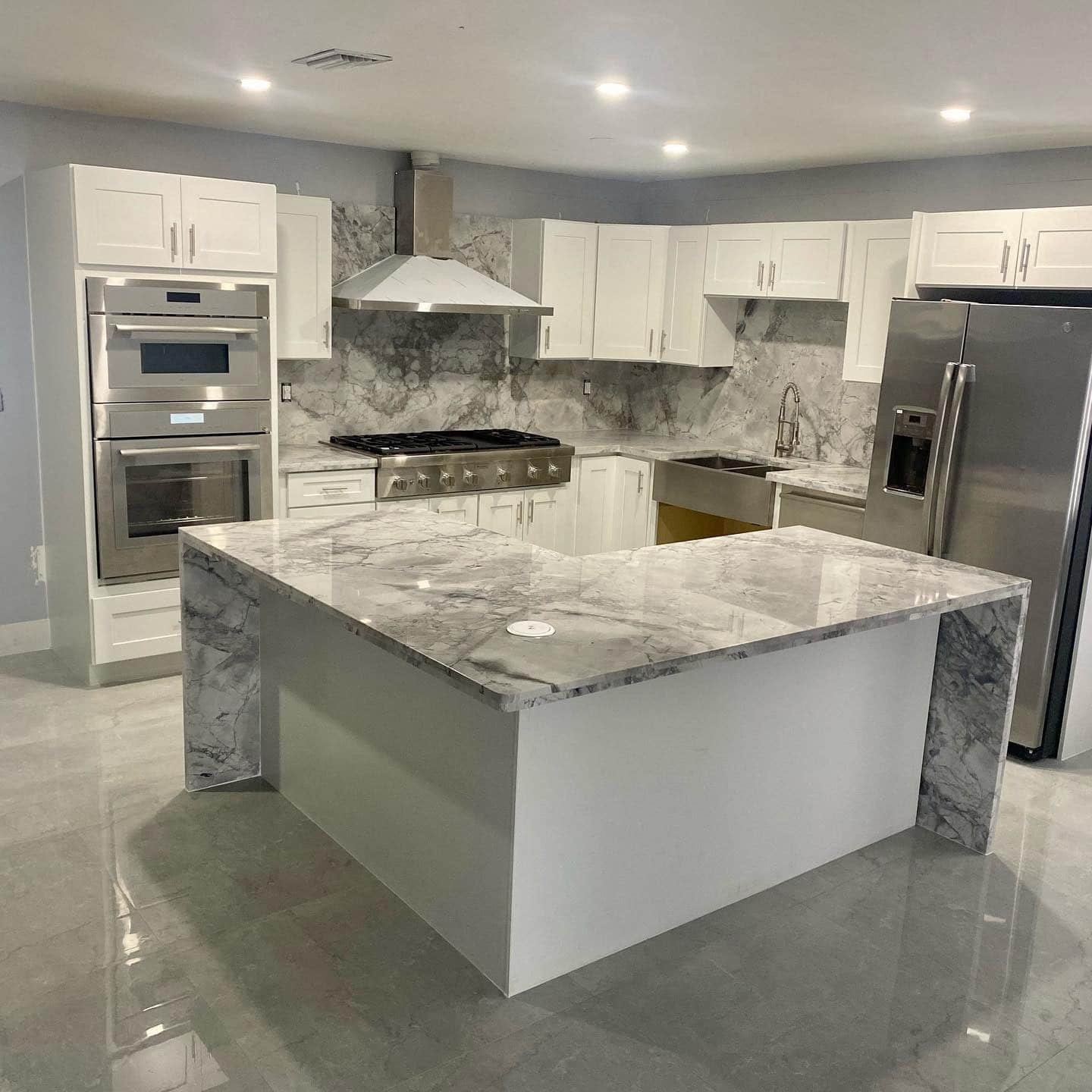 1. Modern Marble Elegance with Soft Gray Veins - gray kitchen backsplash ideas