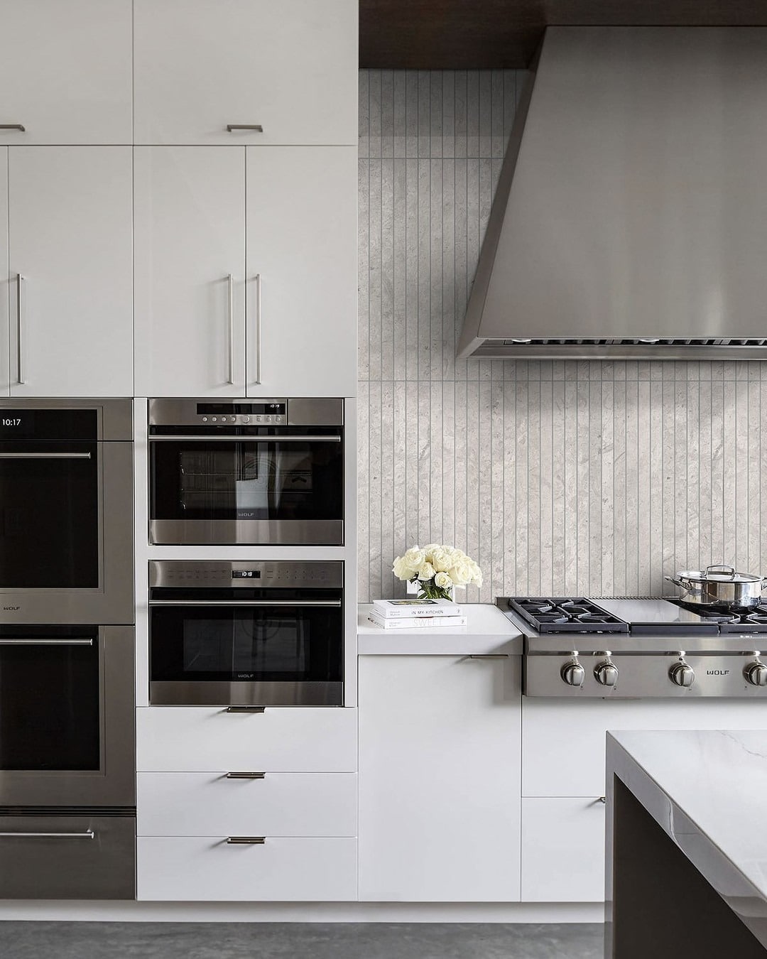 12. Streamlined Elegance in Linear Gray Stone - gray kitchen backsplash ideas