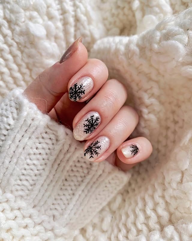 2. Icy Glow with Black Snowflake Art - easy winter nail ideas