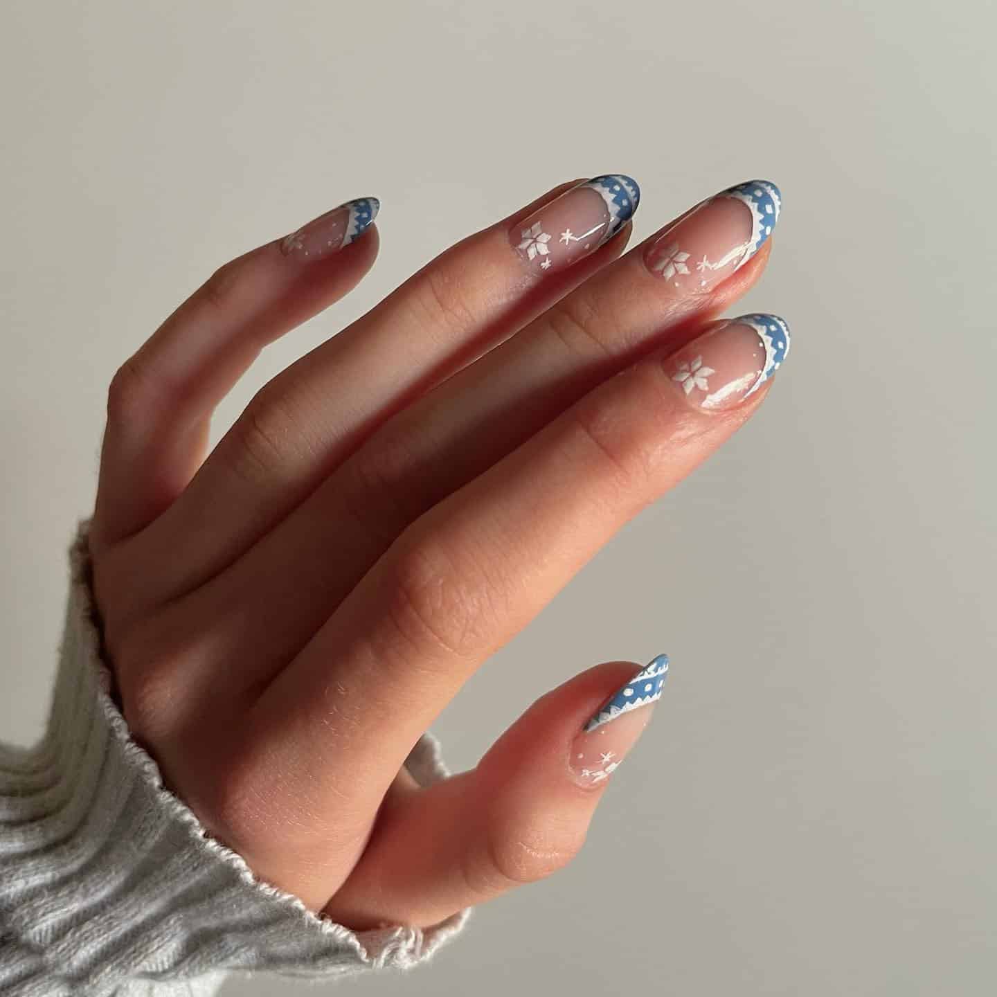 4. Blue-Tipped French with Dainty Snowflakes - easy winter nail ideas