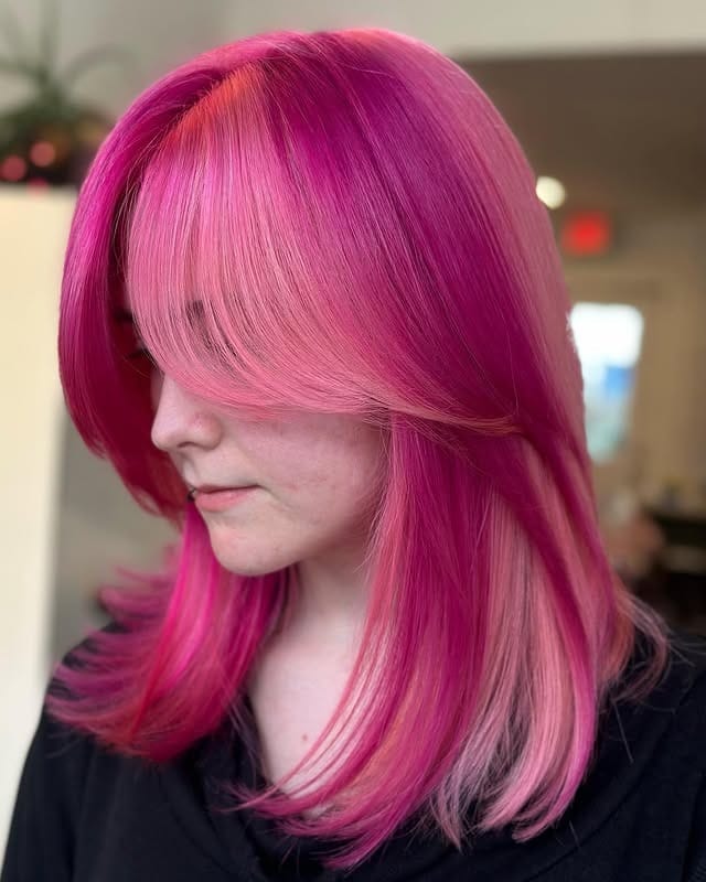 2. Soft Magenta Layers with Feathered Bangs - Dark Pink Hair Color