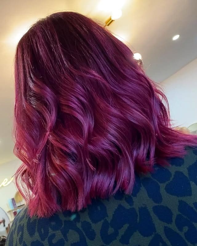9. Subtle Burgundy-Pink Waves with Soft Sheen - Dark Pink Hair Color