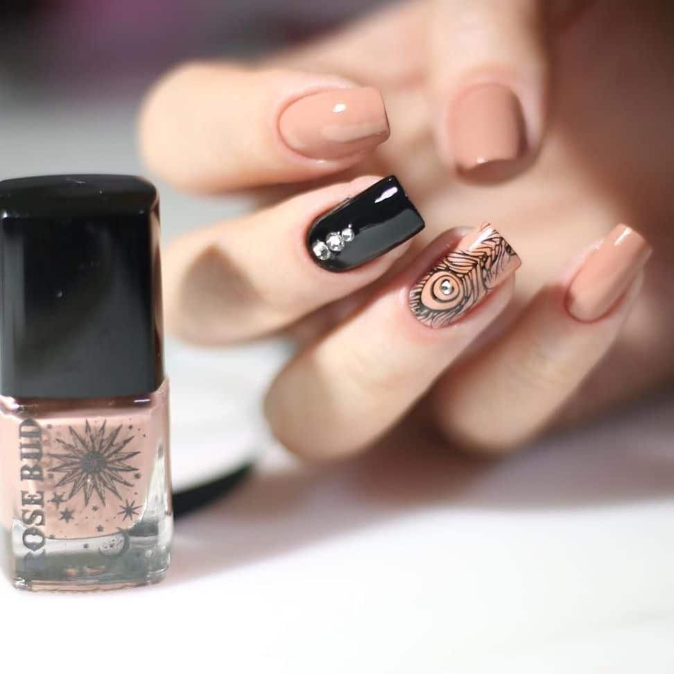 3. Midnight Nude Elegance - feather nail ideas