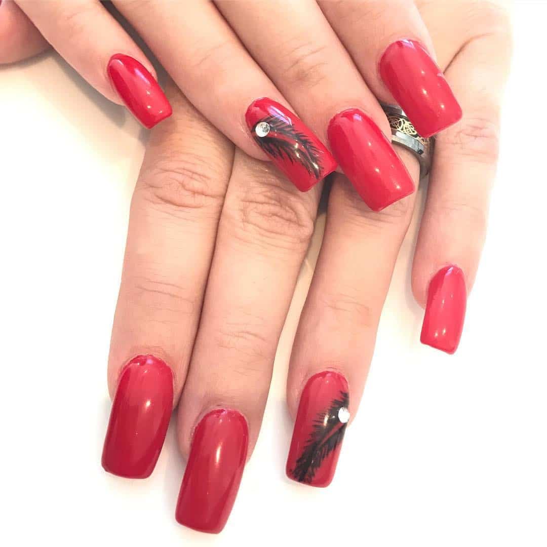 10. Crimson Feather Statement Nails - feather nail ideas