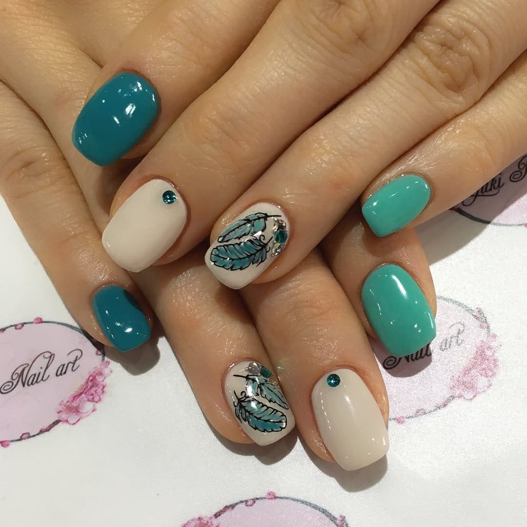 20. Teal Feather Charm Nails - feather nail ideas