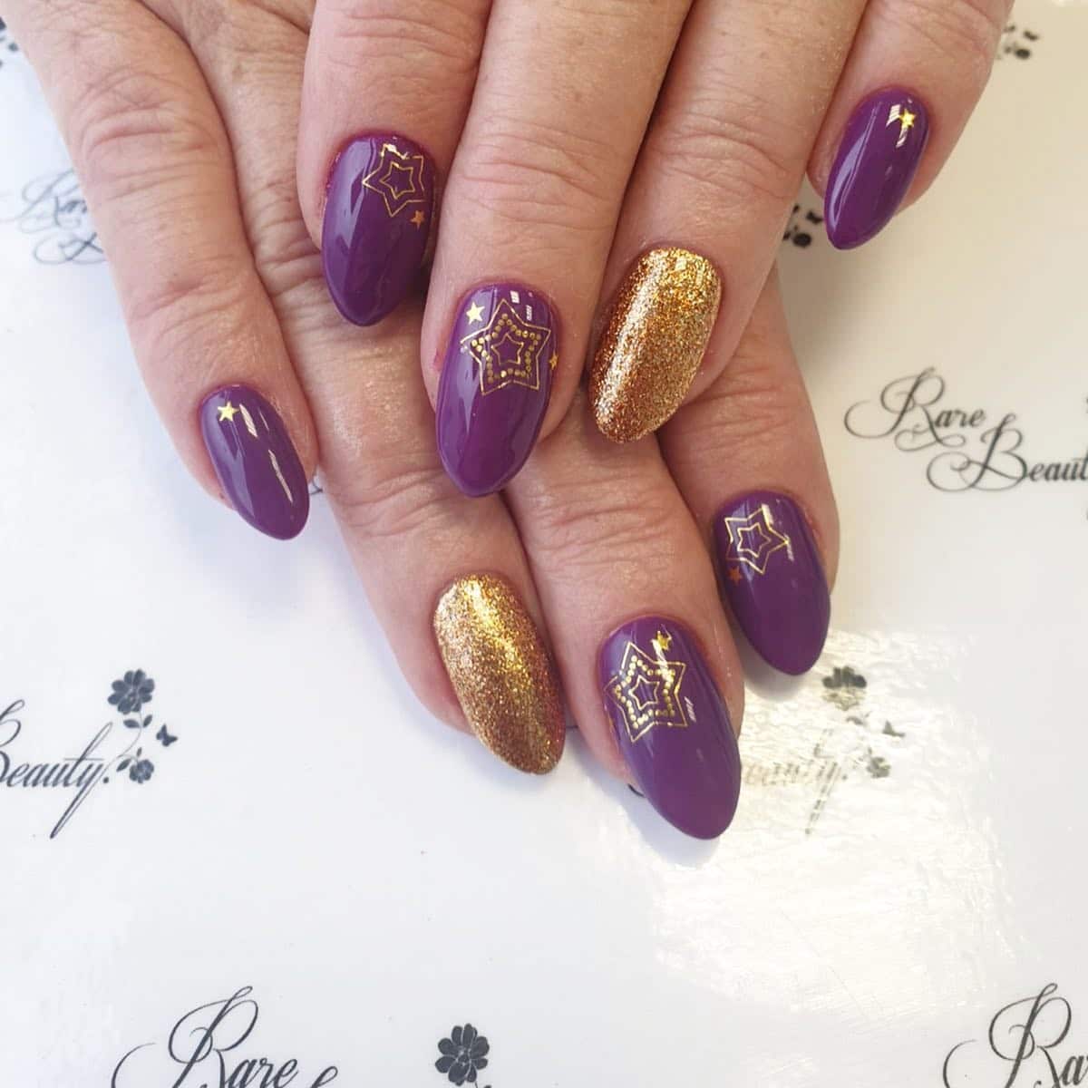 4. Golden Starburst Violet Glam - gold and purple nail ideas