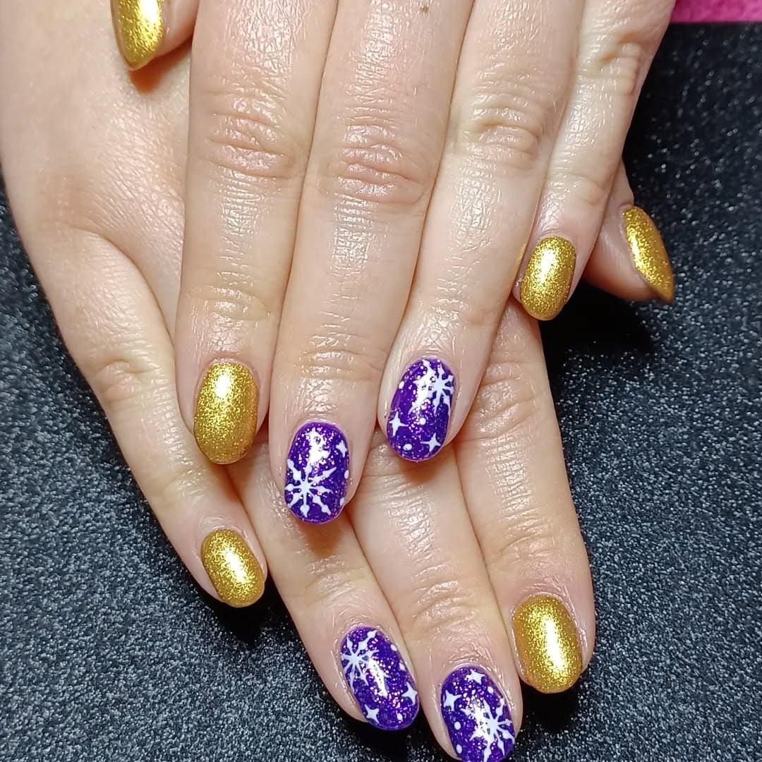 15. Golden Stardust on Purple Frost - gold and purple nail ideas