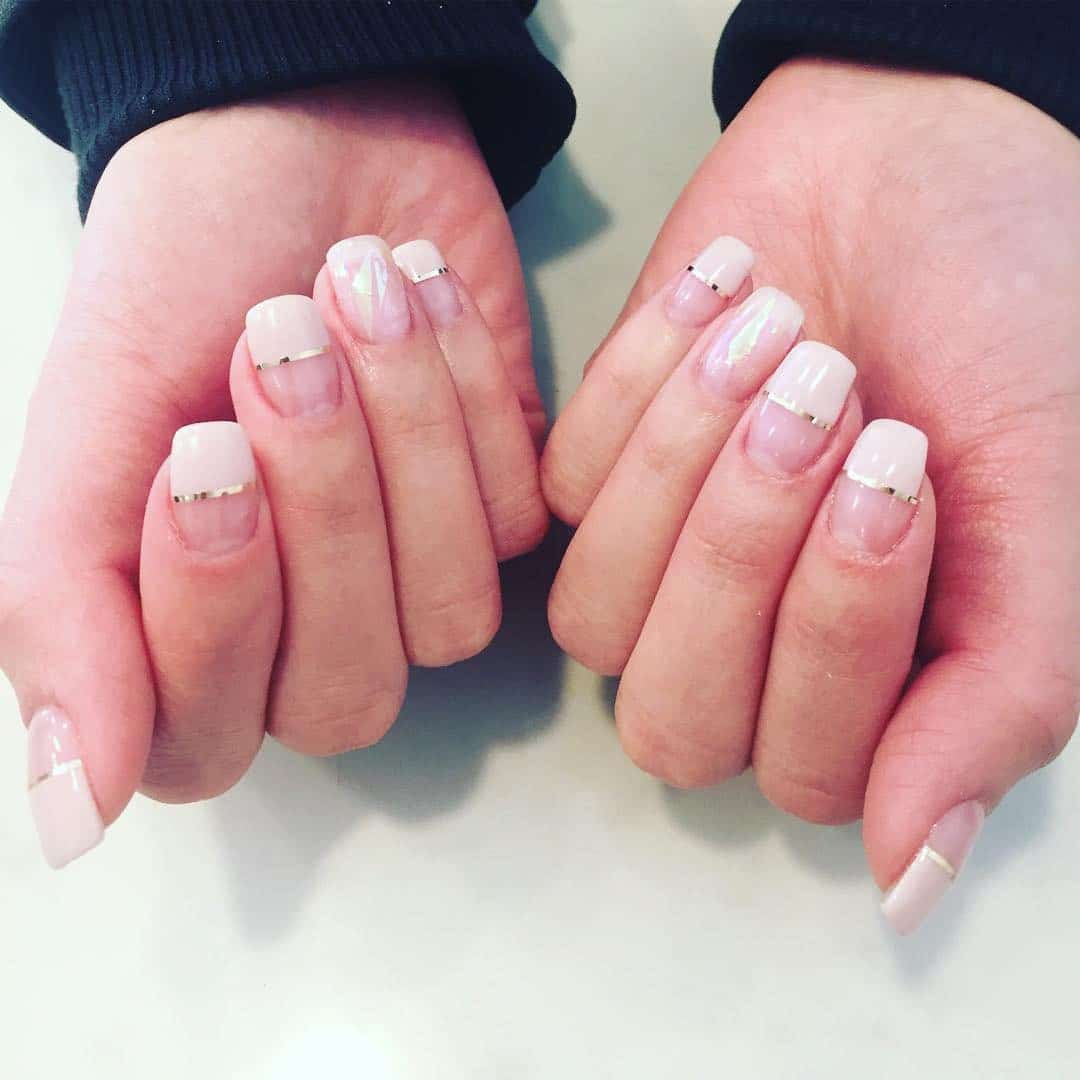 20. Soft Nude Divide with Gold Line - half nail ideas