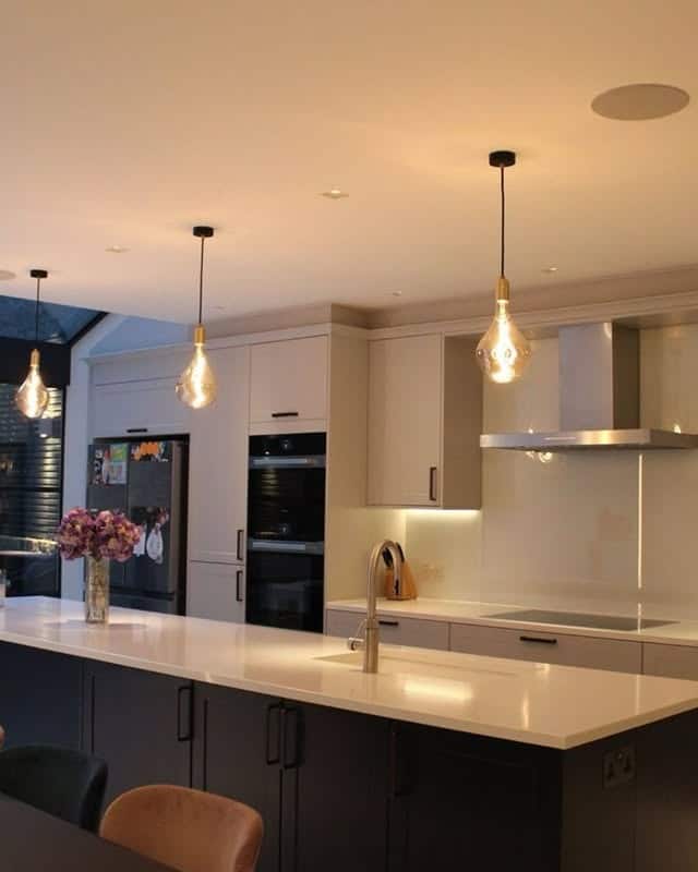 3. Soft Industrial Glow with Amber Lighting - kitchen lighting ideas
