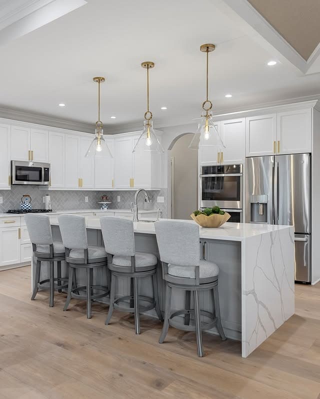 20. Bright Elegance in White and Brass - kitchen lighting ideas