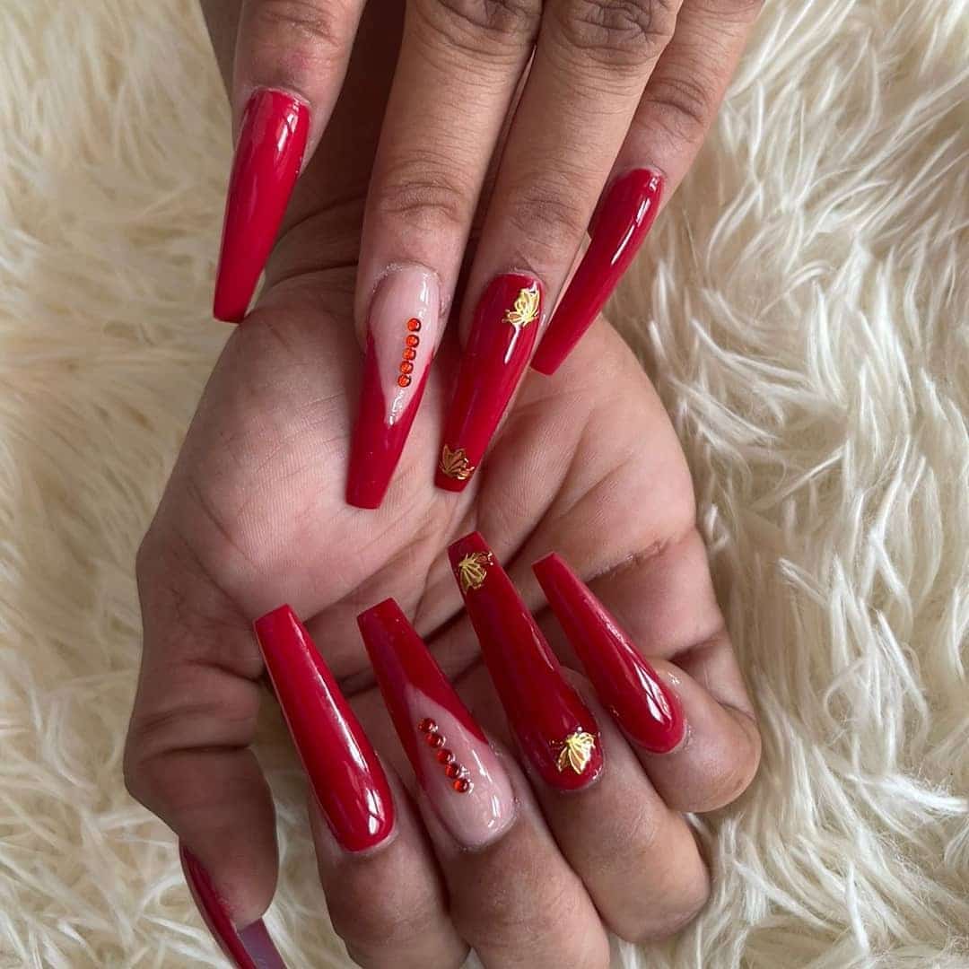 5. Ruby Charm with Gold Touch - jamaican nail ideas
