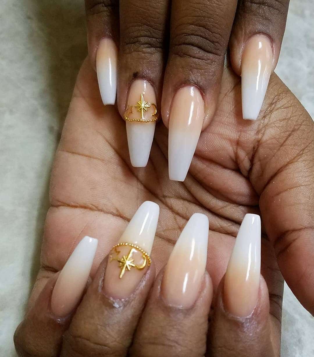 11. Golden Glow Ombre with Star Accents - jamaican nail ideas