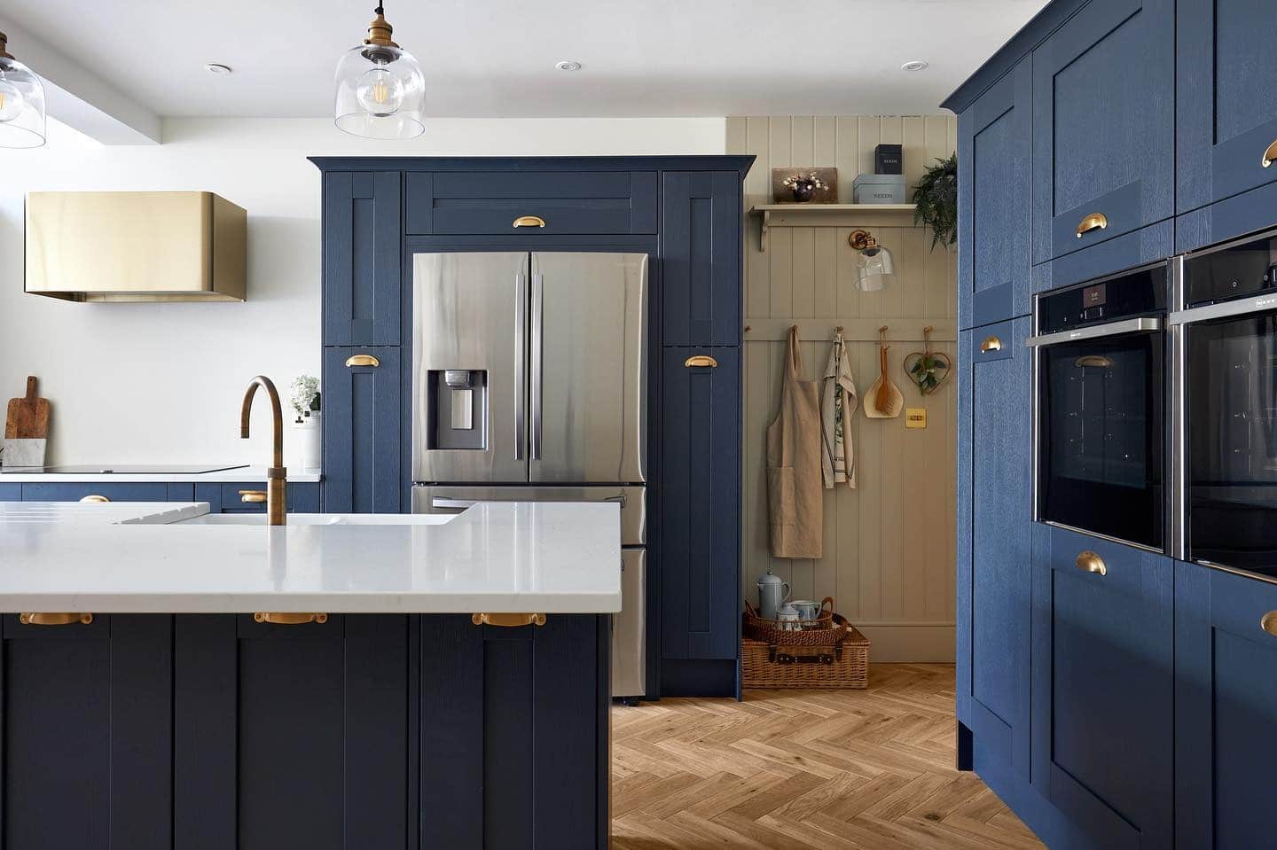 15. Classic Blue with Brass and Herringbone Warmth - dark blue kitchen ideas