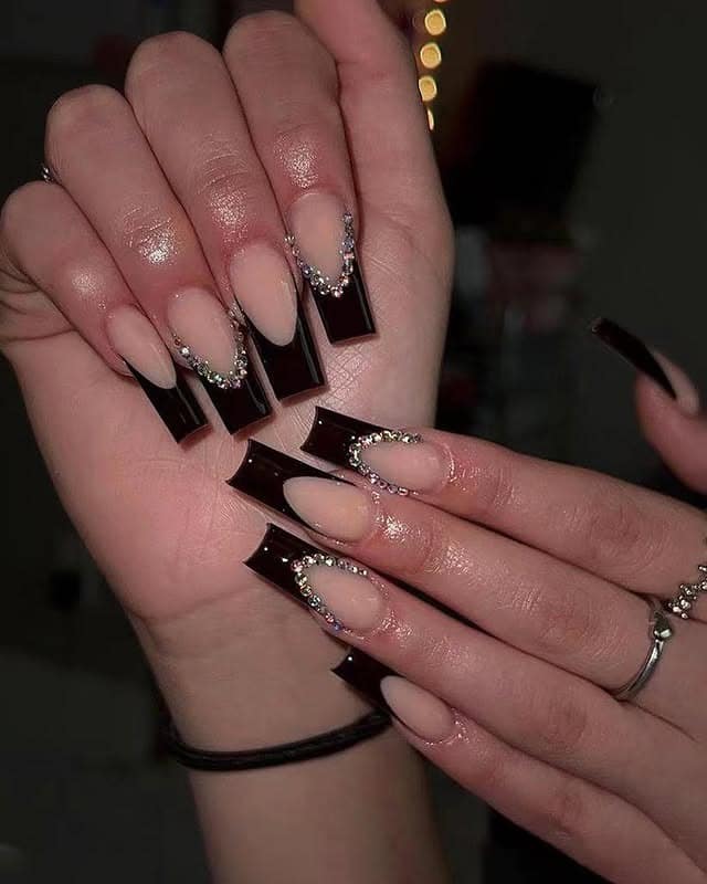 3. Nude and Black V-Tip with Rhinestone Detailing - long coffin nail ideas