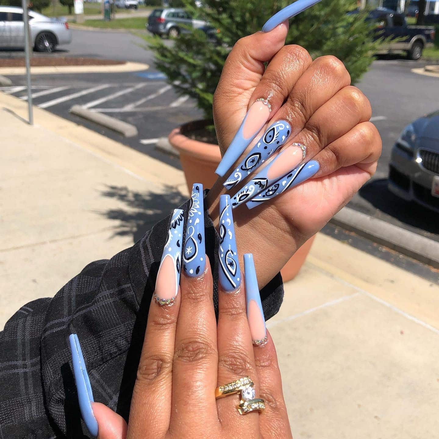4. Blue Paisley Art on Nude Base - long coffin nail ideas