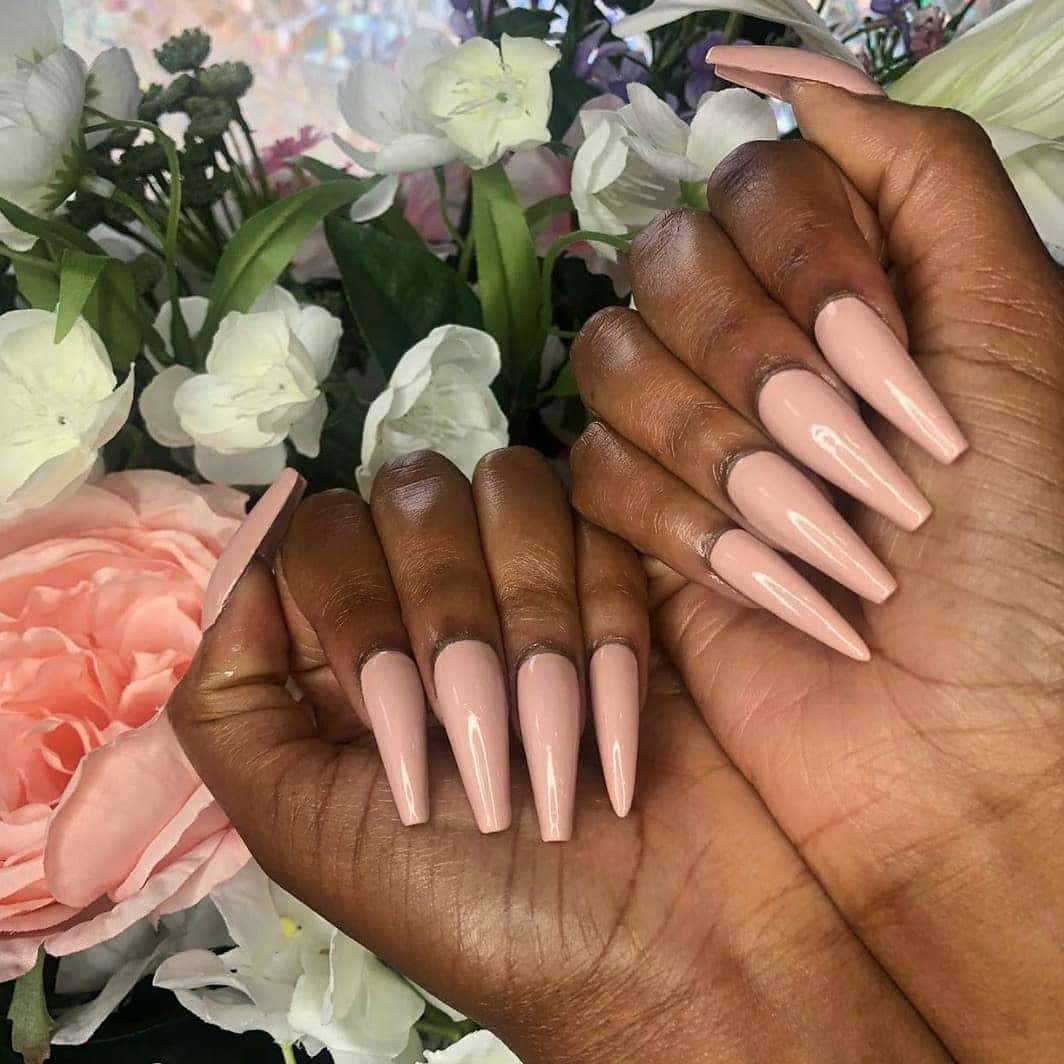 10. Nude Perfection with High Gloss Finish - long coffin nail ideas