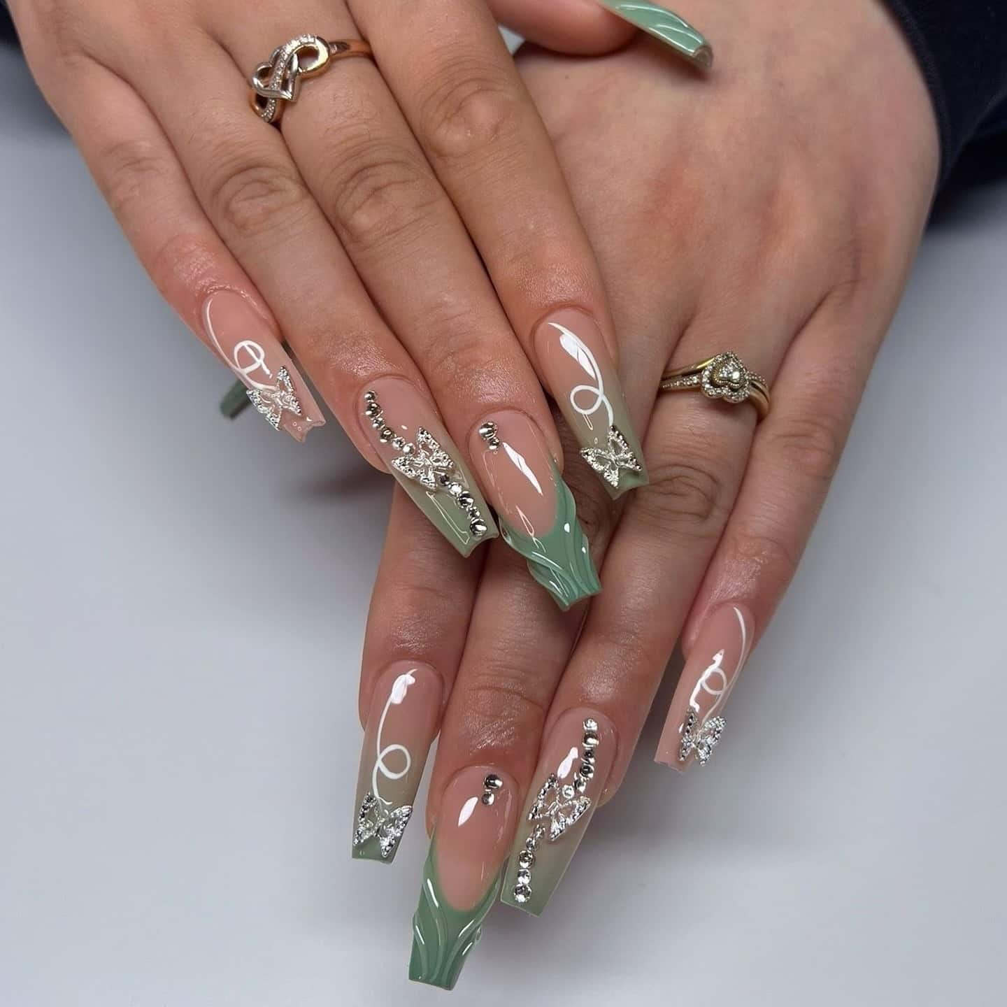 14. Green Elegance with Rhinestone Embellishments - long coffin nail ideas