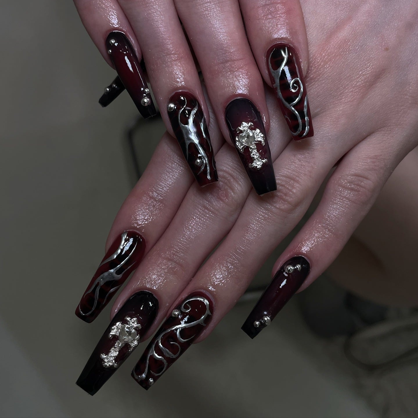 16. Dark Cherry Chrome with Cross Detailing - long coffin nail ideas