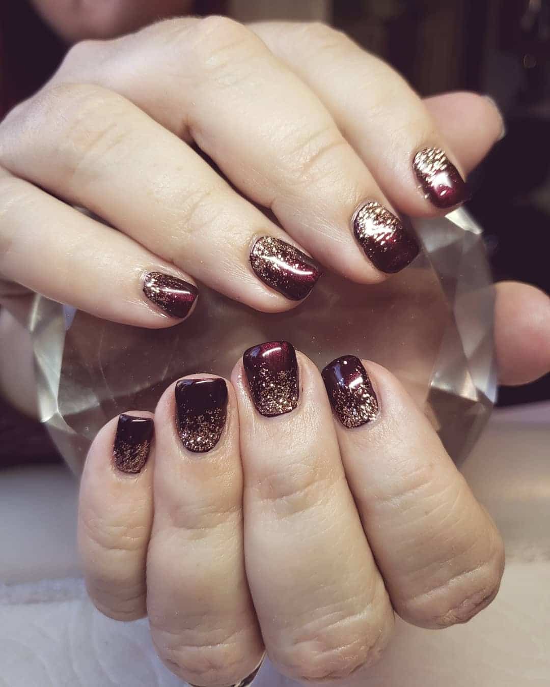 12. Gold Dust Gradient Elegance - maroon and gold nail ideas