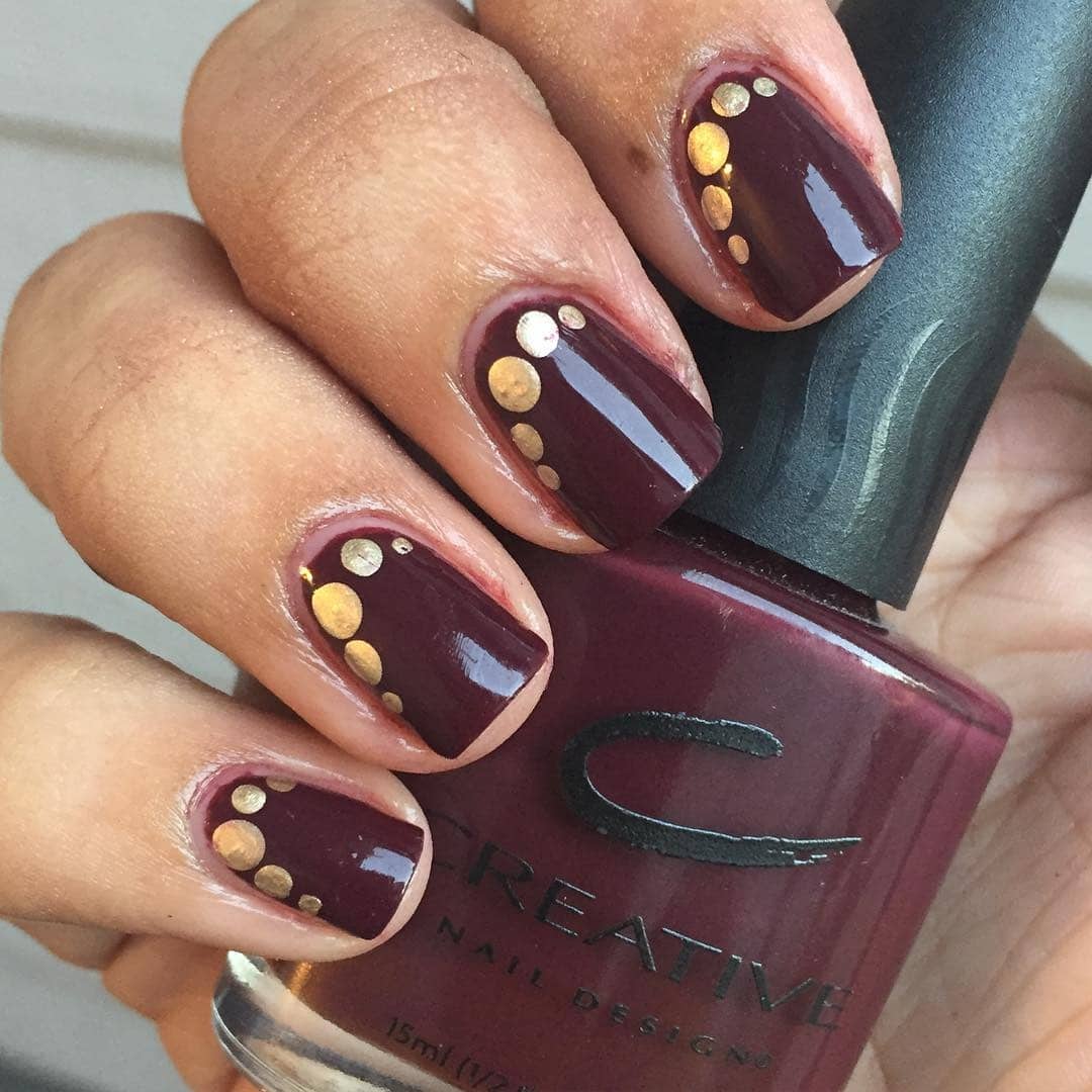 13. Polished Maroon with Metallic Accents - maroon and gold nail ideas