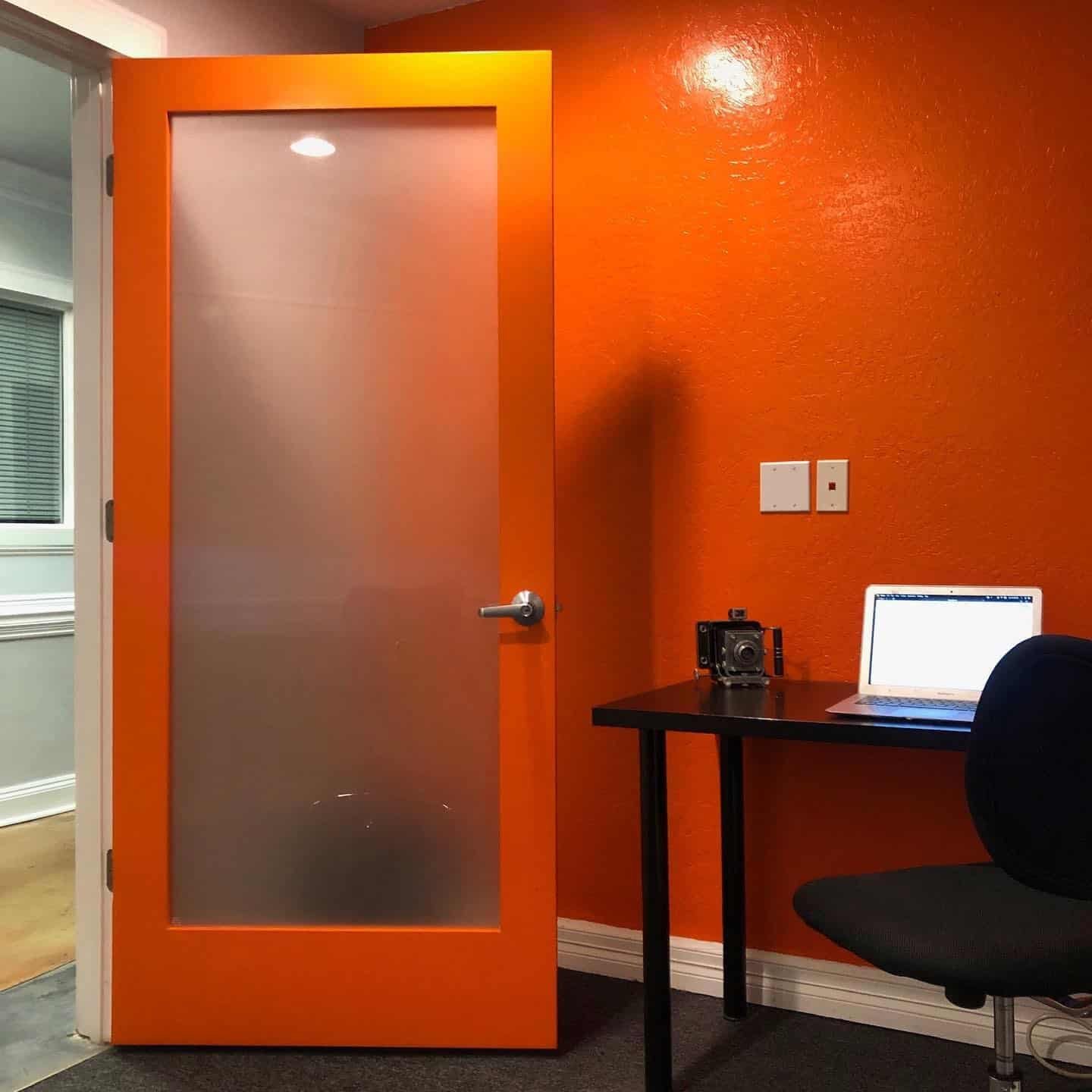 2. Bold Energy in a Compact Workspace - orange office ideas