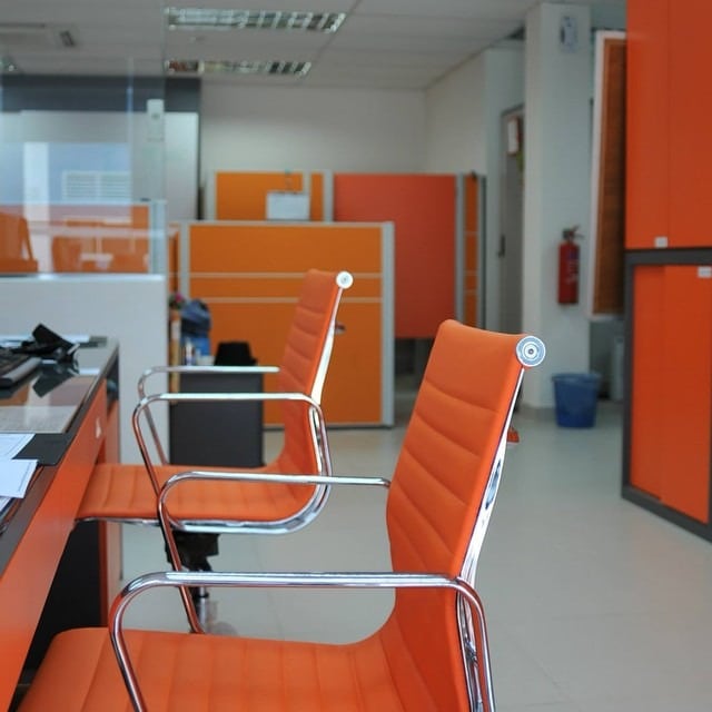 3. Crisp Modern Efficiency with Orange Accents - orange office ideas